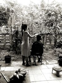 Boys standing against trees