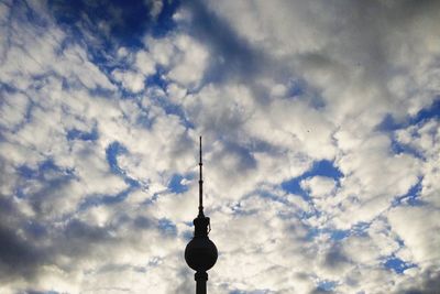 Low angle view of eiffel tower against cloudy sky