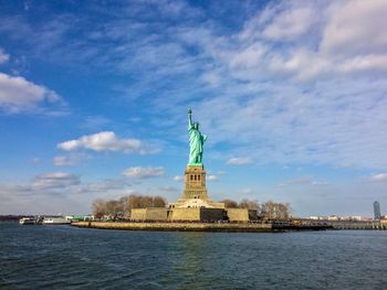 Statue of liberty against cloudy sky