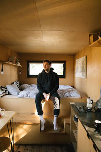 Portrait of young woman sitting at home