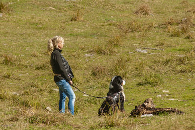 Full length of man with dog on grass