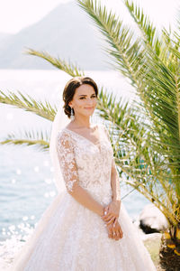 Smiling bride against lake