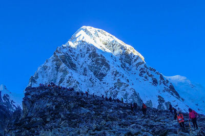 Scenic view of snowcapped mountains against clear blue sky