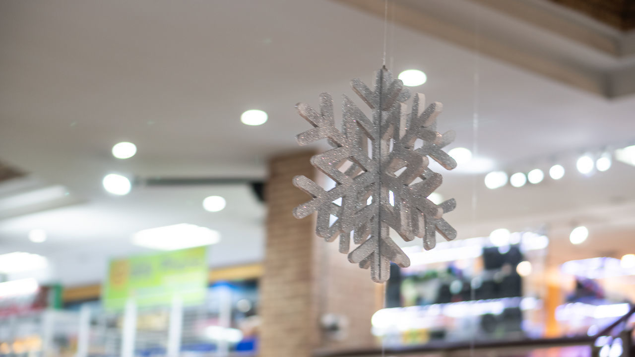 LOW ANGLE VIEW OF ILLUMINATED LIGHTS HANGING FROM CEILING