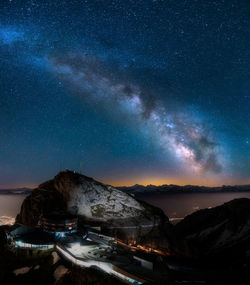 Scenic view of mountains against sky at night