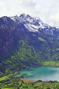 Scenic view of lake and mountains against sky