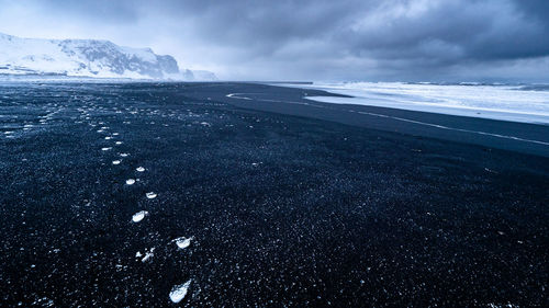 Scenic black beach under evening sky