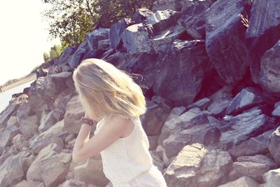 Rear view of girl standing on rock