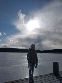 Full length of man standing on lake against sky