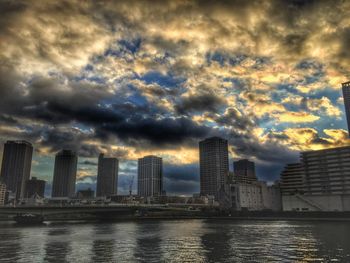 Cityscape against cloudy sky
