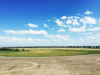 Scenic view of field against cloudy sky