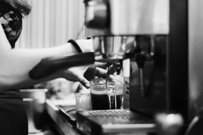 Barista making fresh coffee for service to customer