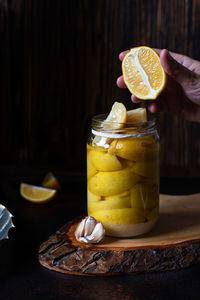 Midsection of person holding drink in jar