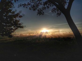 Scenic view of field against sky during sunset