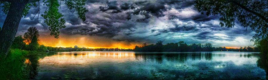 Reflection of cloudy sky on water at sunset