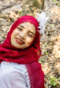 Young woman wearing red hijab in public park