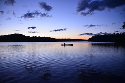 Scenic view of lake against sky at sunset