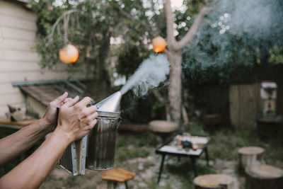 Cropped hand of woman holding umbrella