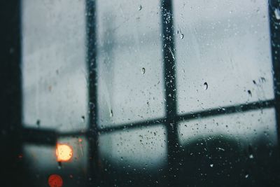 Full frame shot of wet glass window in rainy season