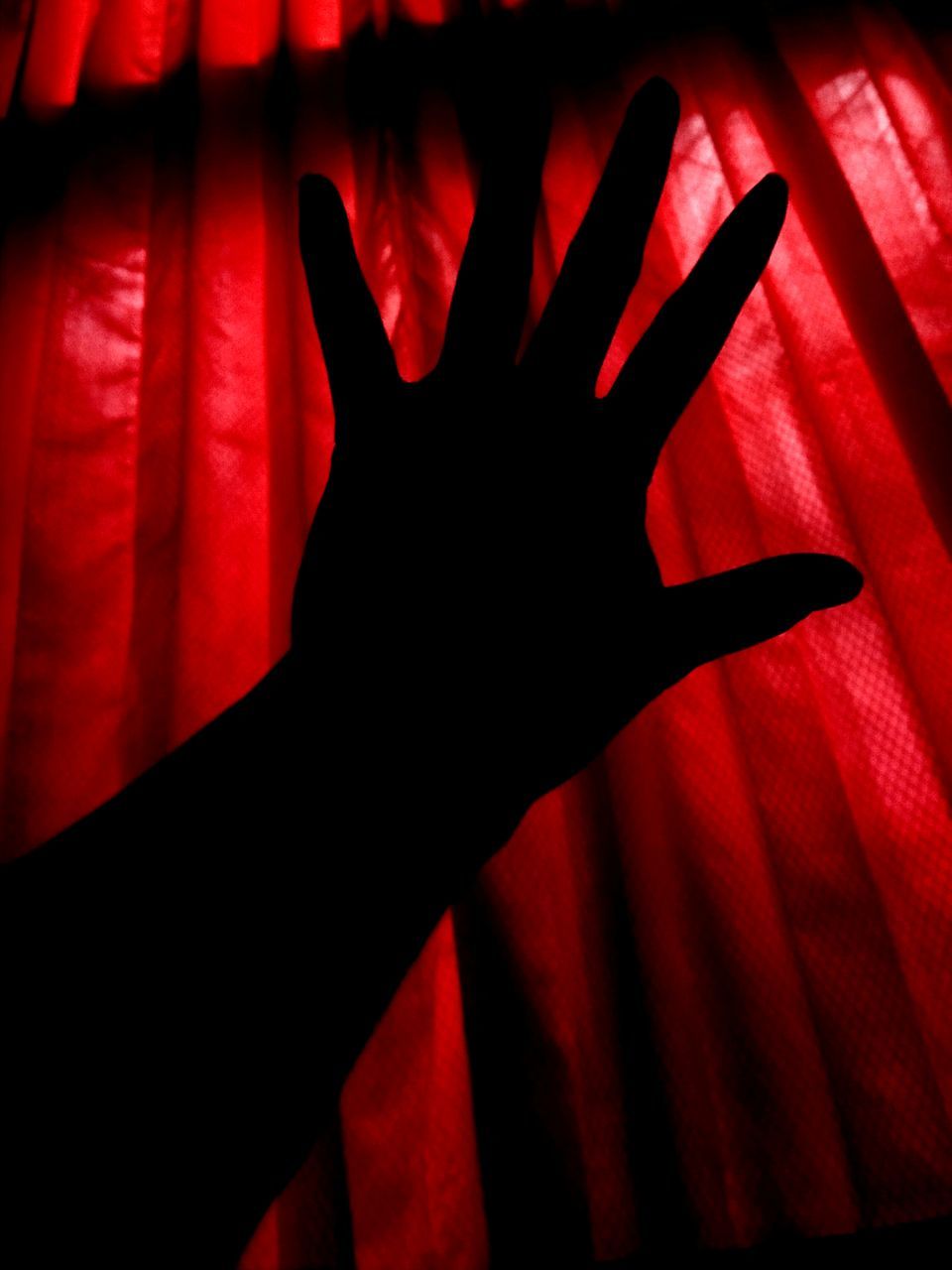 CLOSE-UP OF PERSON HAND WITH RED LIGHT