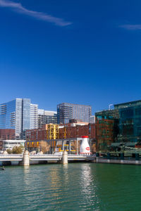 View of modern buildings against clear blue sky