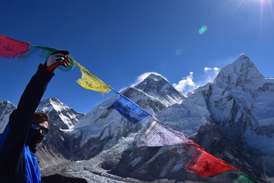 Man touching prayer flag during winter