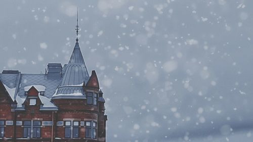 Low angle view of building against sky during winter