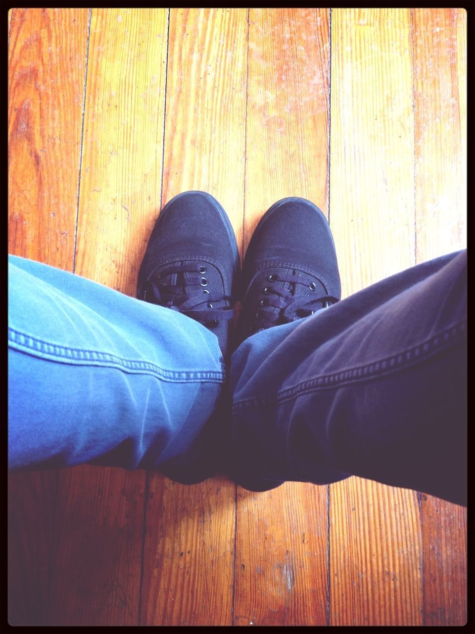 low section, person, shoe, footwear, human foot, transfer print, personal perspective, jeans, indoors, auto post production filter, high angle view, standing, canvas shoe, lifestyles, hardwood floor, pair, wood - material