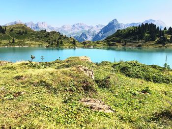 Scenic view of lake and mountains against sky