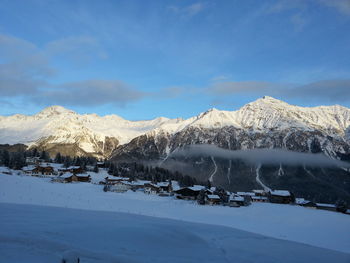 Scenic view of snow covered mountains against sky