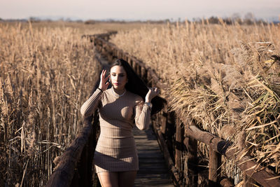 Young woman standing on field