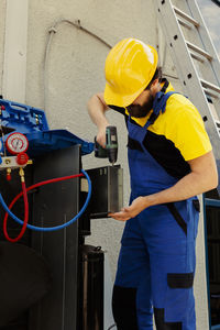 Rear view of man working in factory