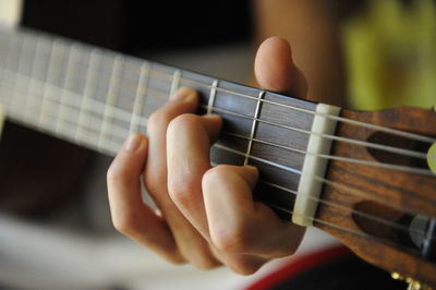 Close-up of man playing guitar