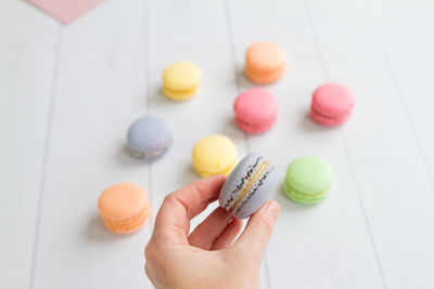 Close-up of hand holding macaroons