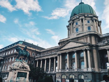 Low angle view of historical building against cloudy sky