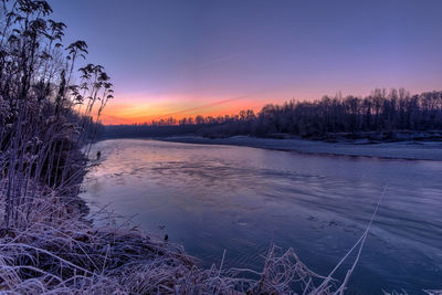 Scenic view of lake against sky during winter