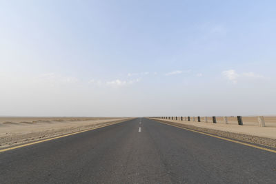 Empty road against clear sky