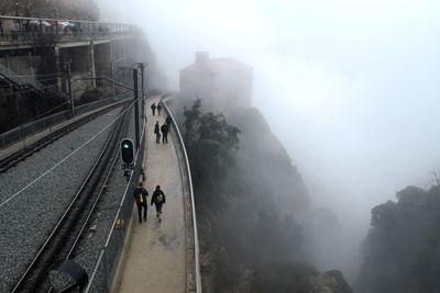 High angle view of road amidst mountains in foggy weather