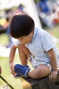 Close-up of baby girl sitting outdoors