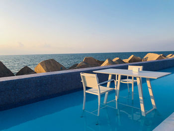 View of swimming pool at beach against clear sky