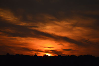 Low angle view of dramatic sky during sunset