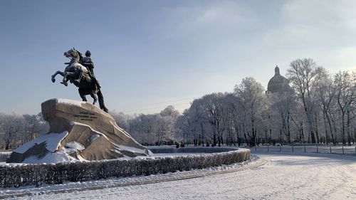 Statue on snow covered landscape