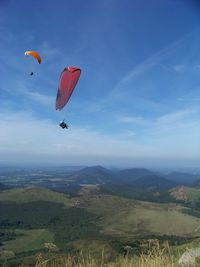 People paragliding over mountain