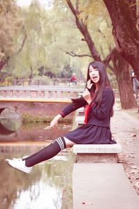 Portrait of young woman sitting outdoors