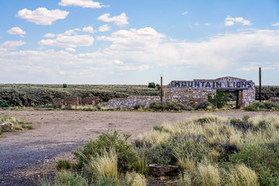 Abandoned built structure on field against sky