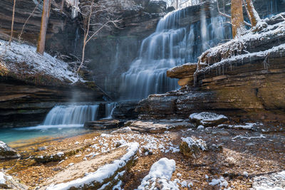 Beautiful machine falls waterfall with snow covered rocks on a sunny cold winter day near  tennessee
