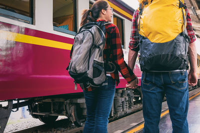 Rear view of people standing on train