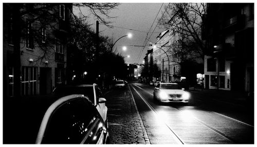 Illuminated city street at night