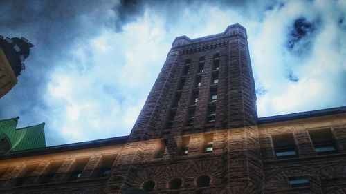 Low angle view of building against cloudy sky