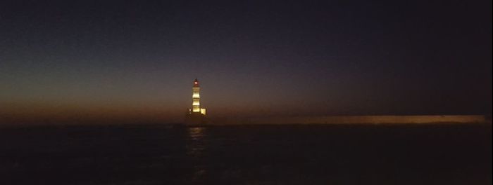 Lighthouse against clear sky at night